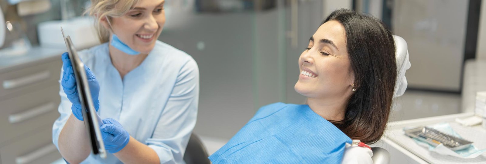 A dental staff showing a tab screen to the patient